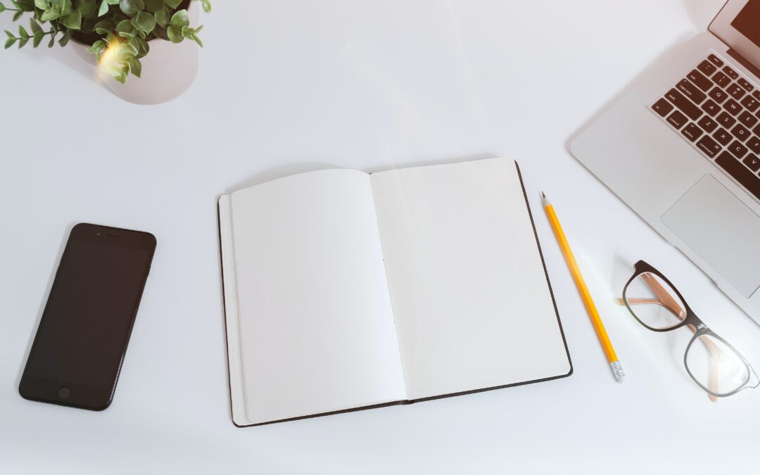 blank page next to a laptop blog writing self doubt