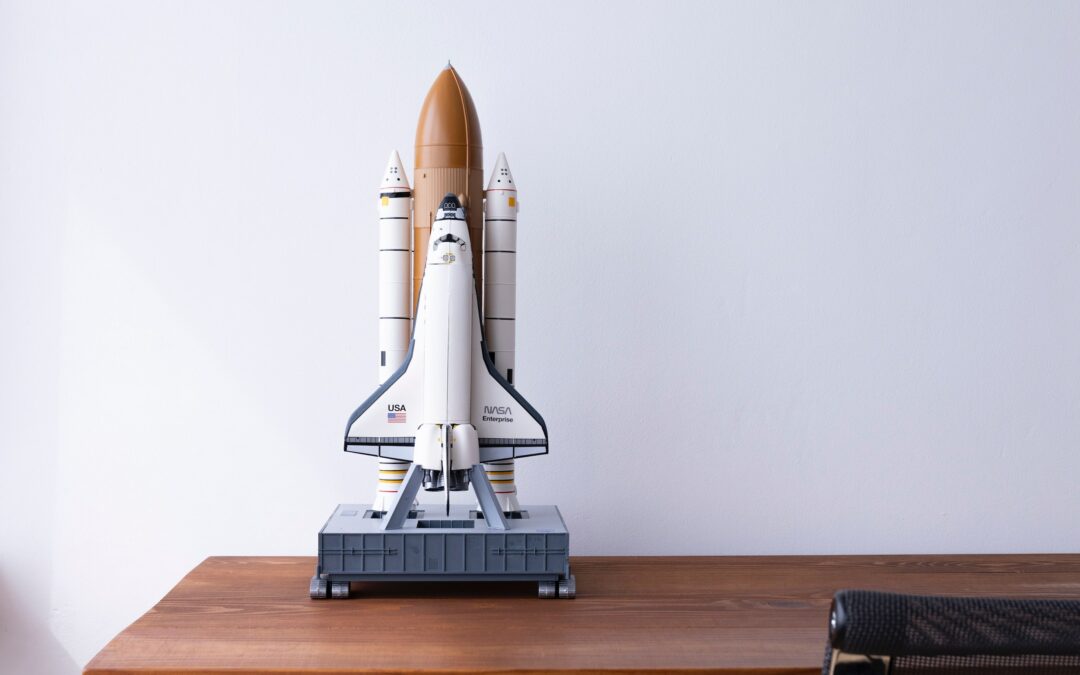 model rocket sitting on a writing desk